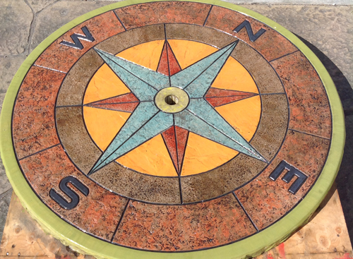 Vibrant colour stained compass inset into the ground