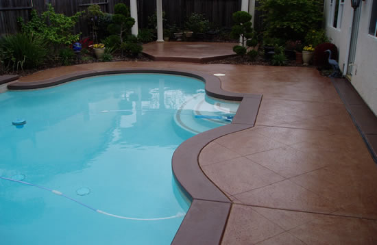 Pool photo with colour stained concrete surround